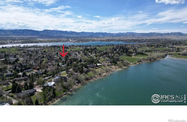 aerial view featuring a water and mountain view