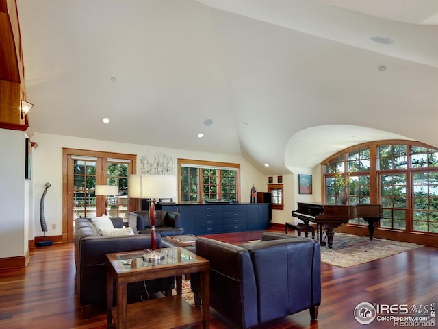 living room with dark hardwood / wood-style flooring and lofted ceiling