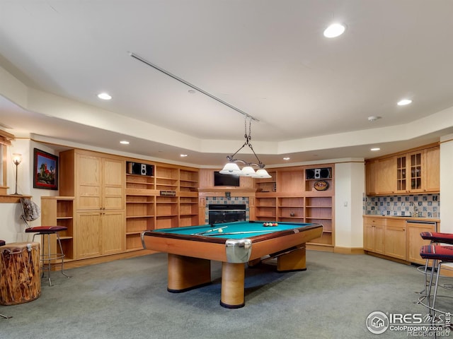 game room featuring a raised ceiling, carpet floors, a tile fireplace, and pool table