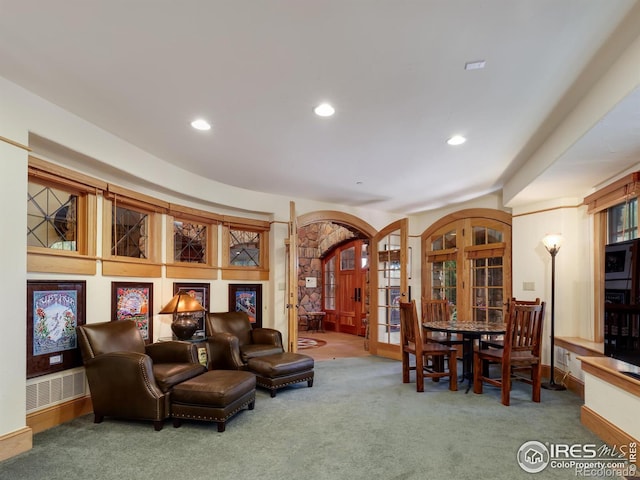 interior space with carpet and french doors