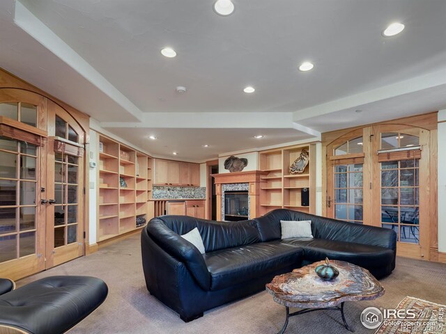 living room featuring light colored carpet and french doors