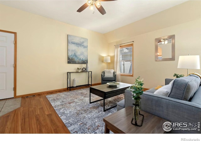 living room with hardwood / wood-style flooring and ceiling fan