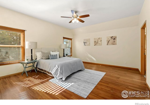 bedroom with hardwood / wood-style flooring and ceiling fan