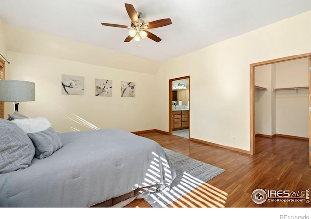 bedroom with a closet, dark hardwood / wood-style floors, connected bathroom, and a spacious closet