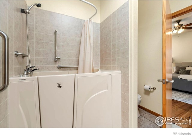 bathroom with ceiling fan, tile patterned floors, and toilet