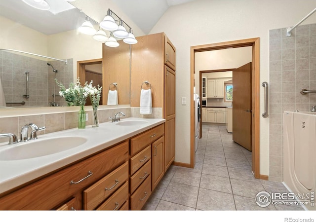 bathroom featuring vaulted ceiling, vanity, and tile patterned flooring