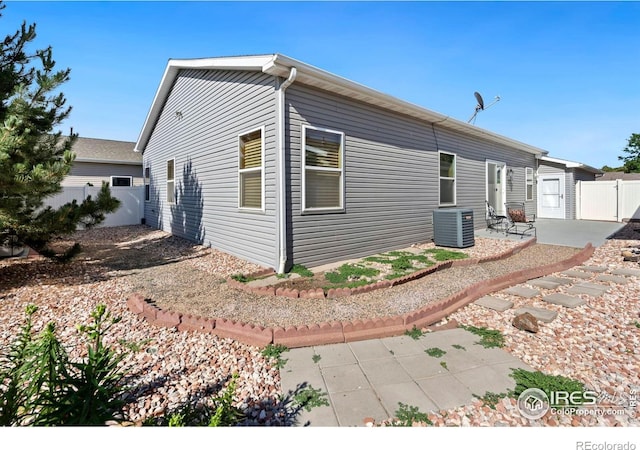 view of home's exterior with a patio area and central air condition unit