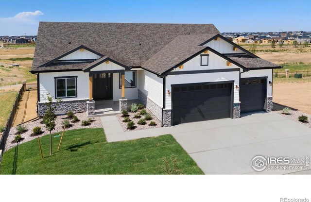 view of front of property featuring a garage and a front yard