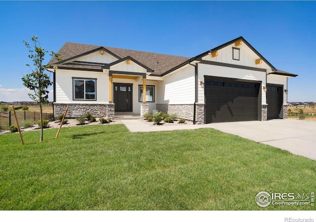 view of front of home with a garage and a front yard