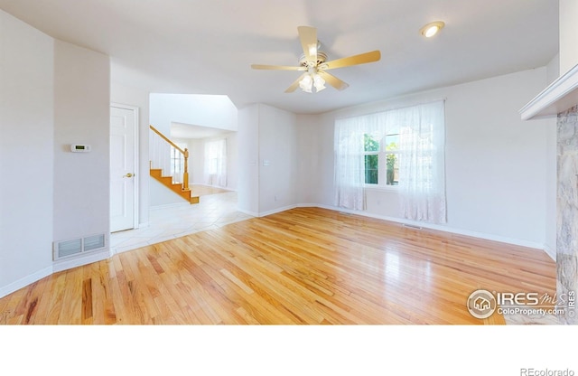 unfurnished living room with light hardwood / wood-style floors and ceiling fan