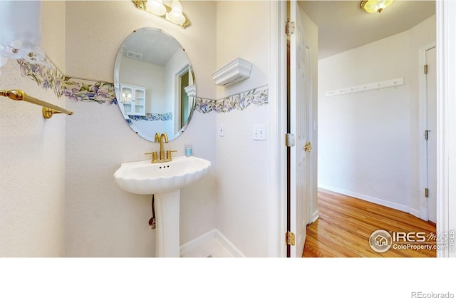 bathroom with wood-type flooring