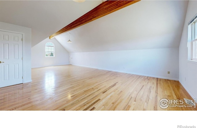 additional living space with vaulted ceiling with beams and light hardwood / wood-style floors