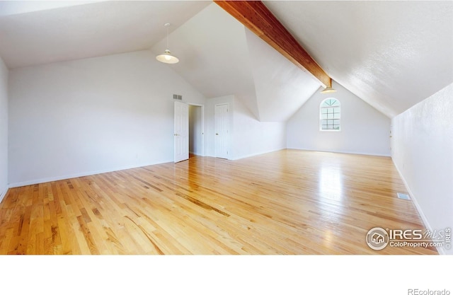 additional living space featuring light hardwood / wood-style flooring and lofted ceiling