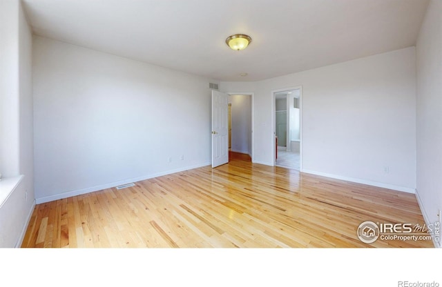 spare room featuring hardwood / wood-style flooring