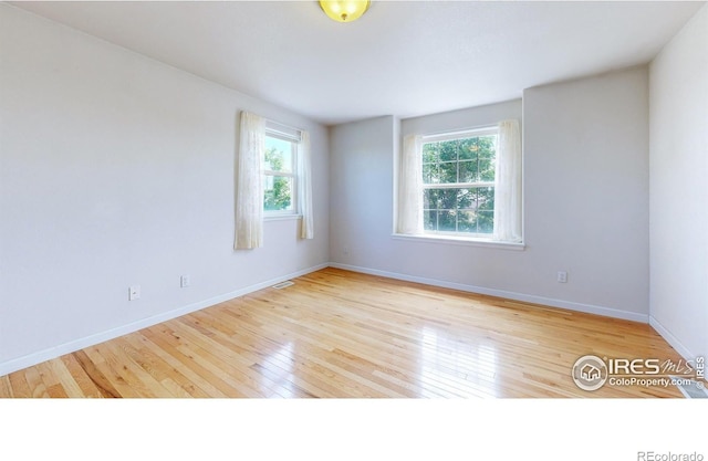 spare room with light hardwood / wood-style floors