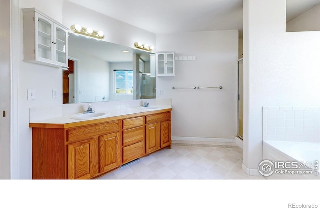 bathroom featuring separate shower and tub and vanity