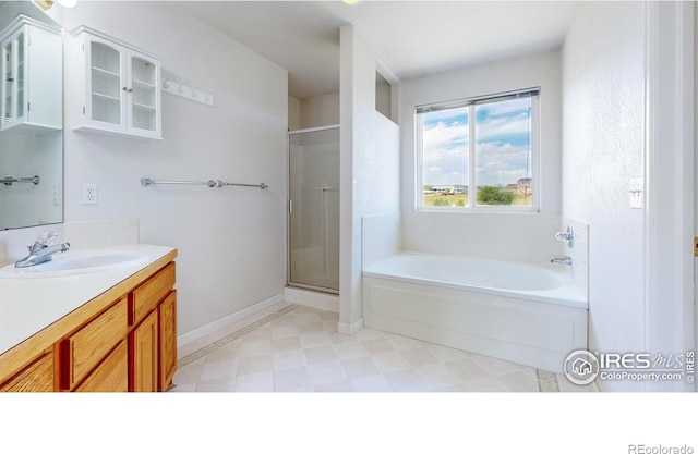 bathroom featuring separate shower and tub and vanity