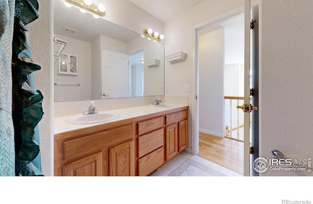 bathroom with tile patterned floors and vanity