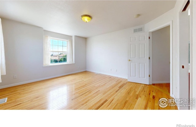 spare room featuring hardwood / wood-style floors