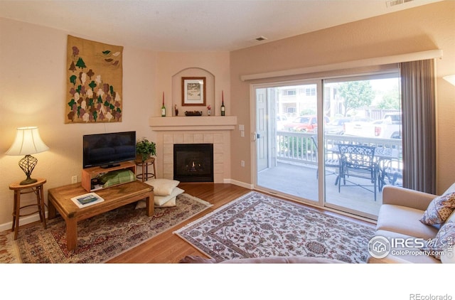 living room featuring a fireplace and hardwood / wood-style floors