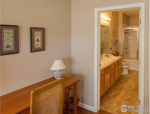 full bathroom featuring enclosed tub / shower combo, vanity, and toilet