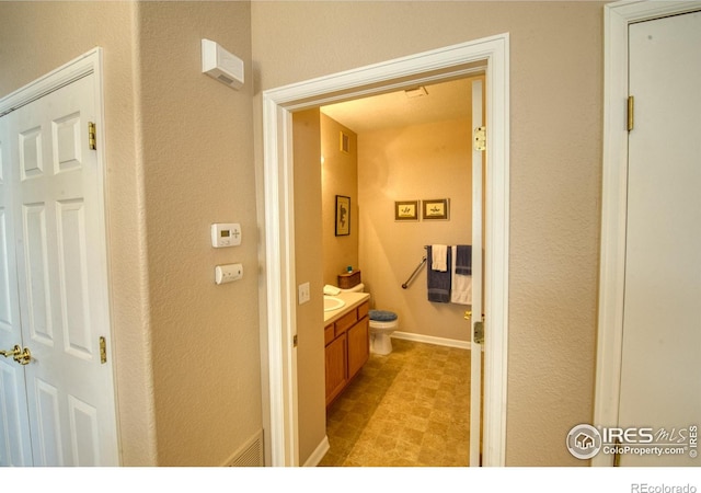 bathroom with vanity and toilet