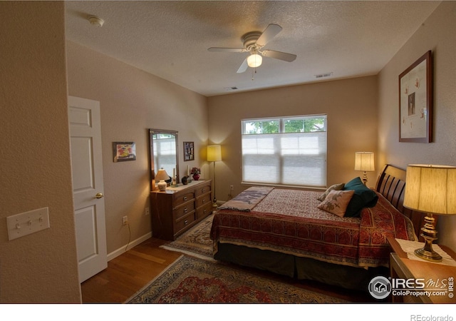 bedroom featuring ceiling fan, a textured ceiling, and wood-type flooring