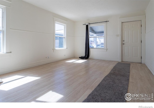 entrance foyer with a wealth of natural light and light hardwood / wood-style floors