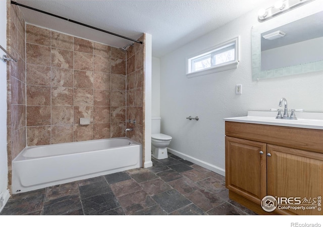 full bathroom with tiled shower / bath combo, toilet, a textured ceiling, and vanity