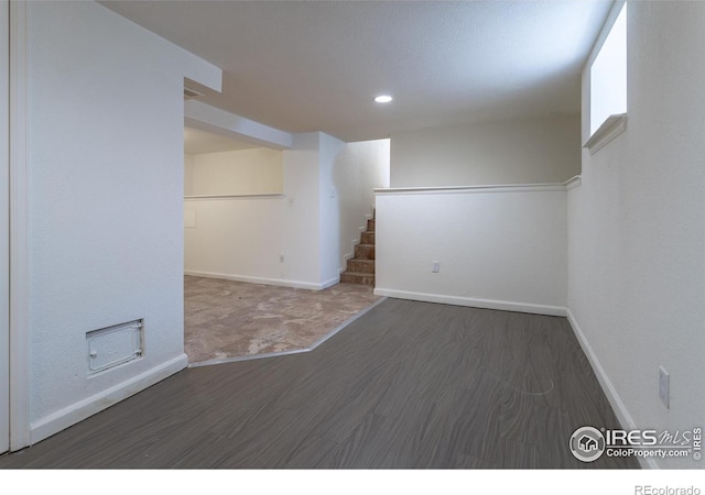 basement with dark hardwood / wood-style flooring