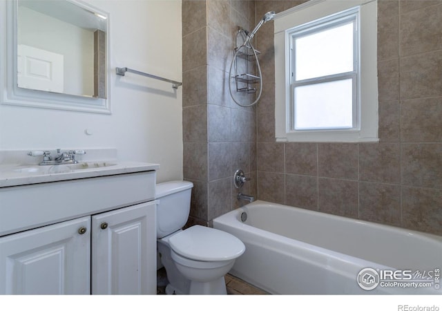 full bathroom featuring vanity, toilet, and tiled shower / bath