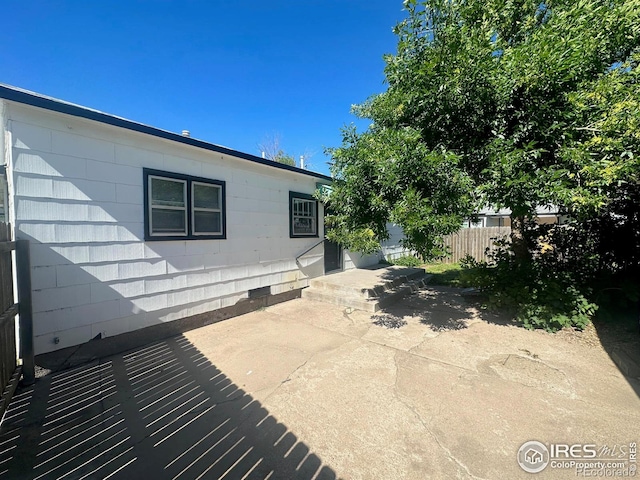 view of side of home with a patio