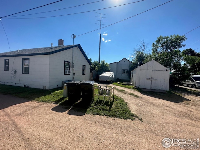 view of side of property with a shed