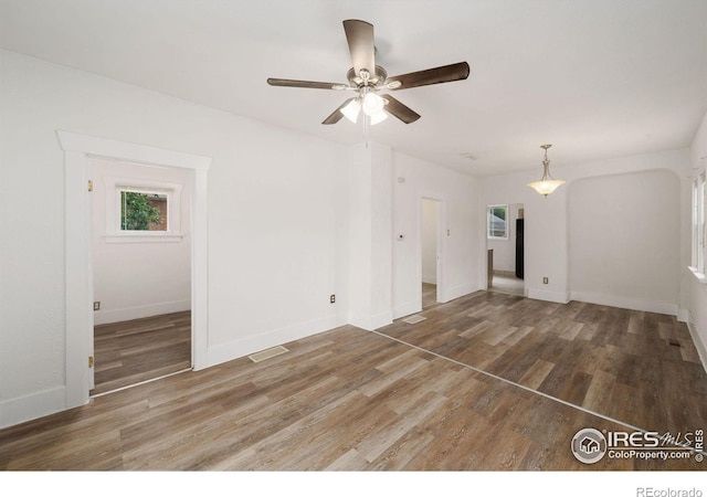 unfurnished room featuring ceiling fan and hardwood / wood-style flooring