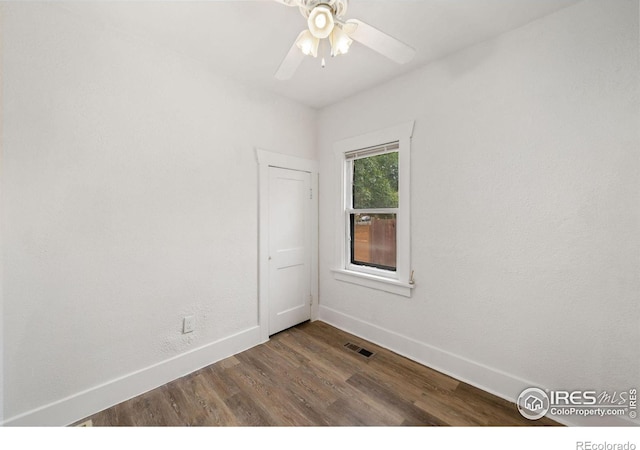 unfurnished room with ceiling fan and dark hardwood / wood-style floors