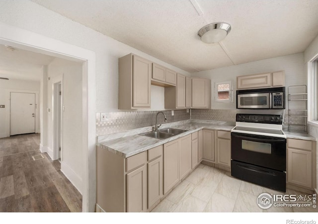 kitchen with decorative backsplash, light hardwood / wood-style floors, sink, and white electric range oven