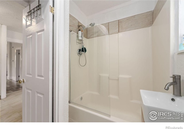 bathroom with bathing tub / shower combination, sink, and tile patterned floors