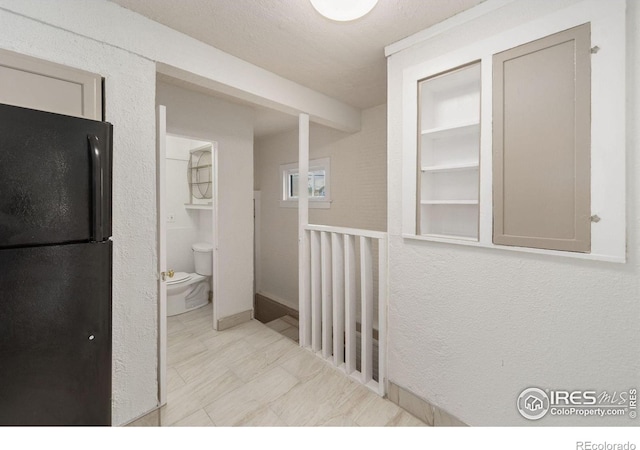 hall featuring light tile patterned flooring