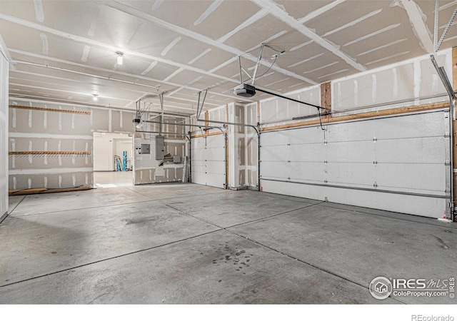 garage featuring electric panel and a garage door opener