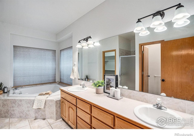 bathroom with tile patterned floors, vanity, and shower with separate bathtub