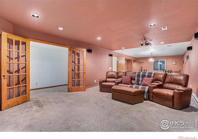 cinema room featuring french doors and carpet