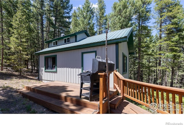 rear view of house featuring a deck