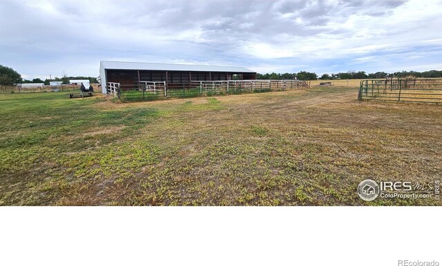 view of yard featuring an outbuilding and a rural view