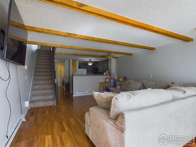 living room featuring a baseboard heating unit, a textured ceiling, wood finished floors, beamed ceiling, and stairs