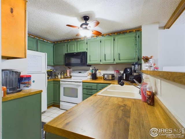 kitchen with a sink, white appliances, a textured ceiling, and wood counters