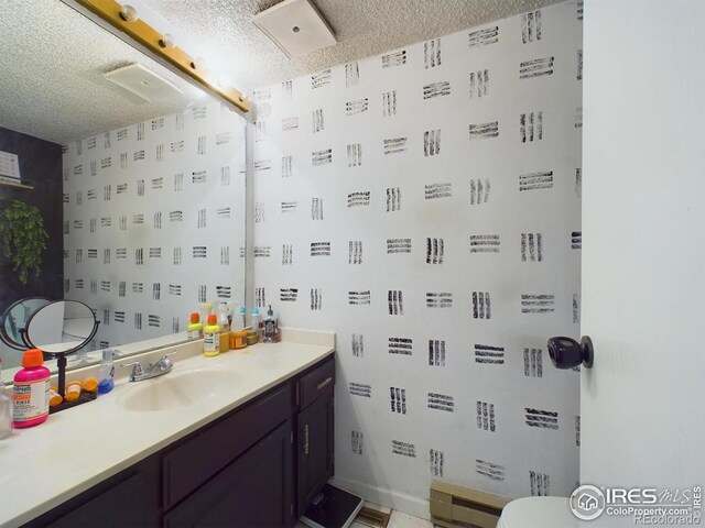 bathroom with vanity and a textured ceiling