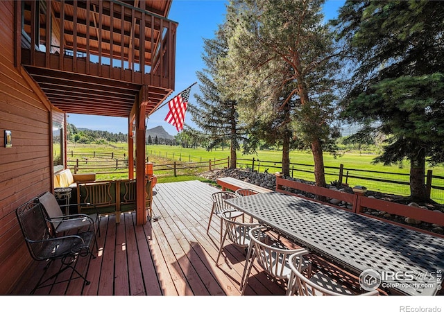 deck featuring a rural view and a yard