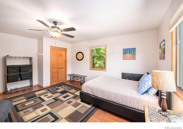 bedroom featuring hardwood / wood-style floors, a closet, and ceiling fan