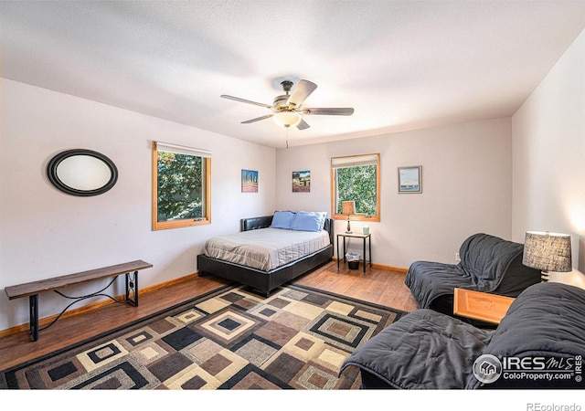 bedroom featuring hardwood / wood-style flooring and ceiling fan