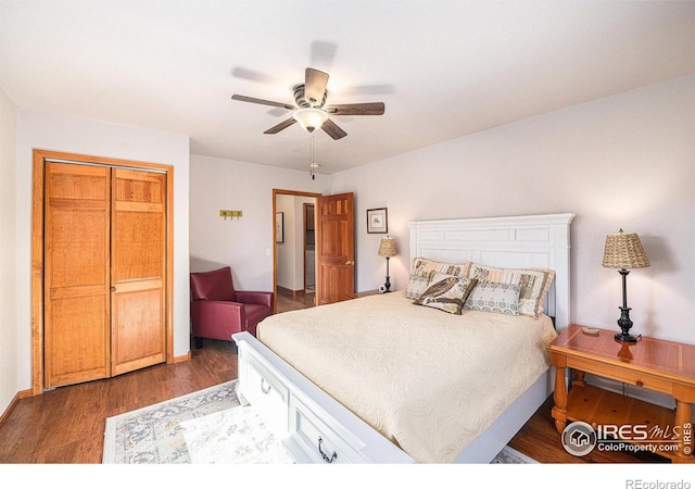 bedroom with dark wood-type flooring, ceiling fan, and a closet